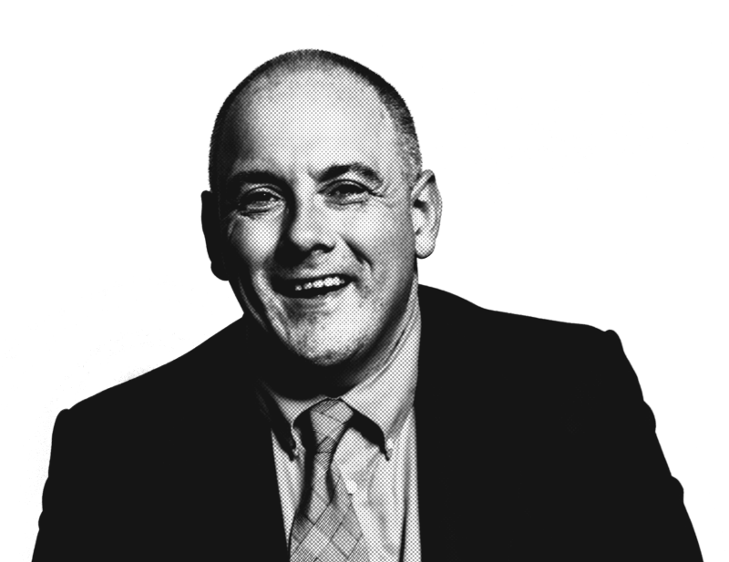 A smiling man in a suit and tie, captured in a high-contrast black and white format, with a halftone texture.