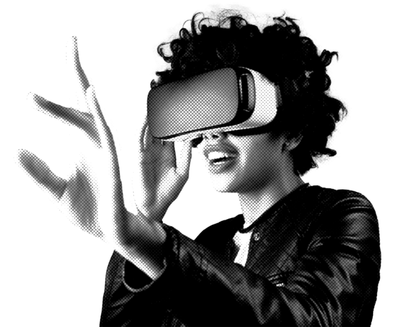 A person with curly hair wears a virtual reality headset and reaches out with one hand, appearing engaged in an immersive experience.