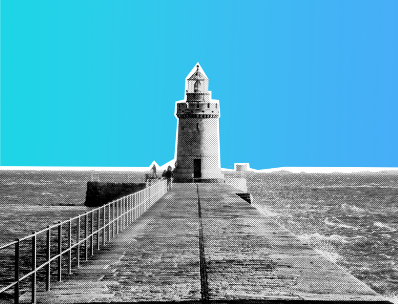 A lighthouse stands at the end of a pier, with waves crashing against the structure. The background features a gradient of blue hues, creating a striking contrast with the black and white lighthouse.