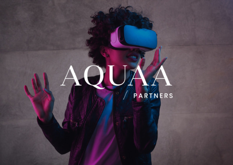 A person with curly hair wears a virtual reality headset, gesturing with their hands. The background features a textured surface, and the text "AQUAA PARTNERS" is displayed prominently.