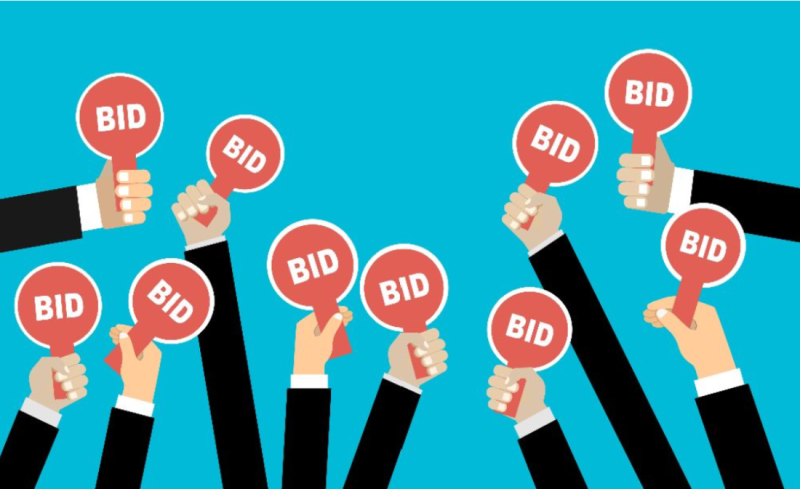 Several hands in suits are raised, holding red paddles with the word "BID" on them against a bright blue background.