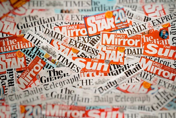 A collage of various newspaper mastheads, including The Guardian, Daily Mirror, The Sun, Daily Star, The Times, Daily Express, and The Daily Telegraph, arranged in a chaotic layout.