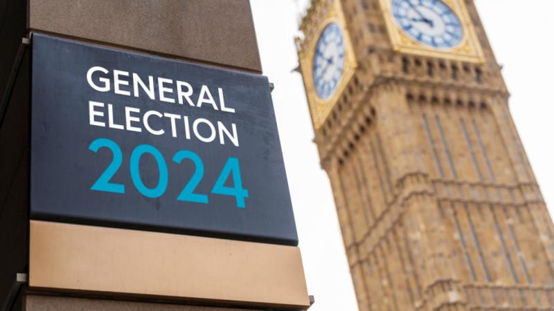 Sign displaying "General Election 2024" in front of the Elizabeth Tower, commonly known as Big Ben, with the clock face visible in the background.