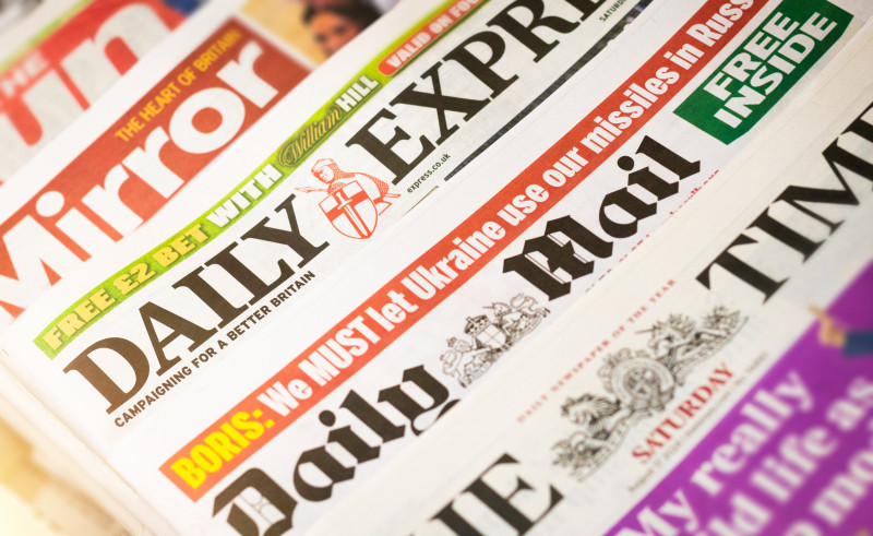 Headlines from various British newspapers, including "Mirror," "Daily Express," and "Daily Mail," showcasing news coverage with bold text emphasizing current events and campaigns.