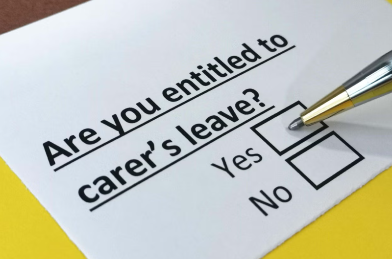 A printed questionnaire asking, "Are you entitled to carer's leave?" with checkboxes for "Yes" and "No." A silver pen is poised to mark an answer.