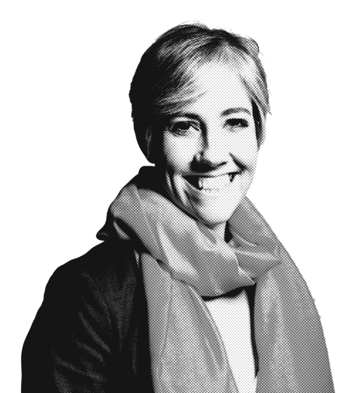 A woman with short hair and a friendly smile wears a light-colored scarf over a dark outfit. The image is black and white with a halftone texture.